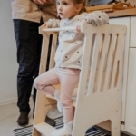 dziewcznka stoi na kitchen helper